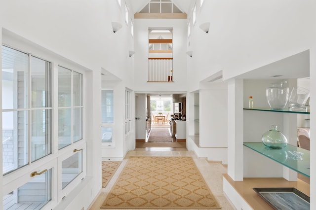 tiled foyer entrance with a high ceiling