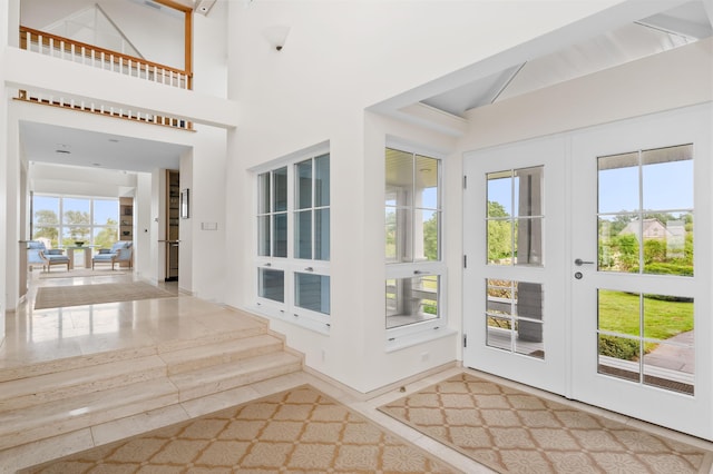 doorway to outside with a towering ceiling and french doors