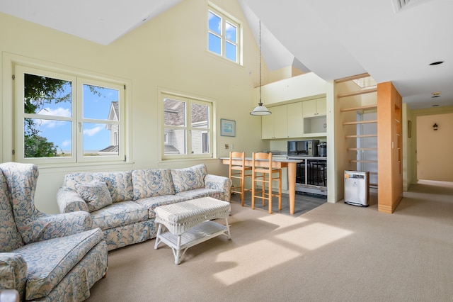 living room with built in shelves, a high ceiling, and light carpet