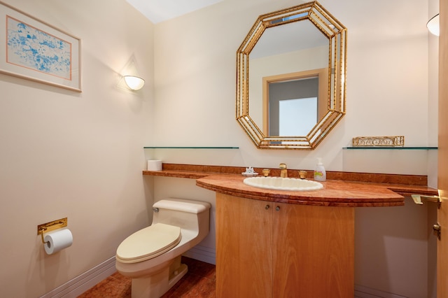 bathroom featuring toilet and vanity