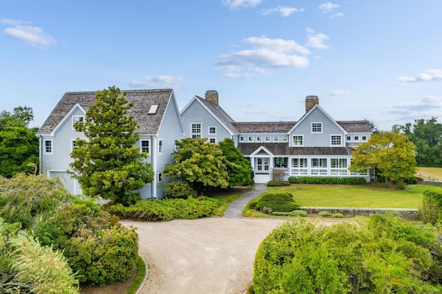 rear view of house with a lawn and a garage