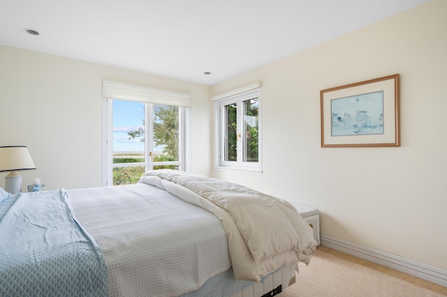 bedroom featuring light carpet