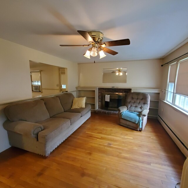 living room with ceiling fan, baseboard heating, light hardwood / wood-style flooring, and a fireplace