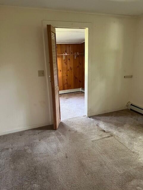 60 Baxter Ave, West Yarmouth, MA 02673 - empty room with carpet flooring and a baseboard heating unit
