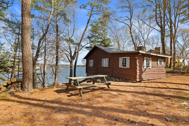23 Pine Ridge Rd, Buzzards Bay, MA 02532 - view of home's exterior with a water view, an outbuilding, faux log siding, and a chimney