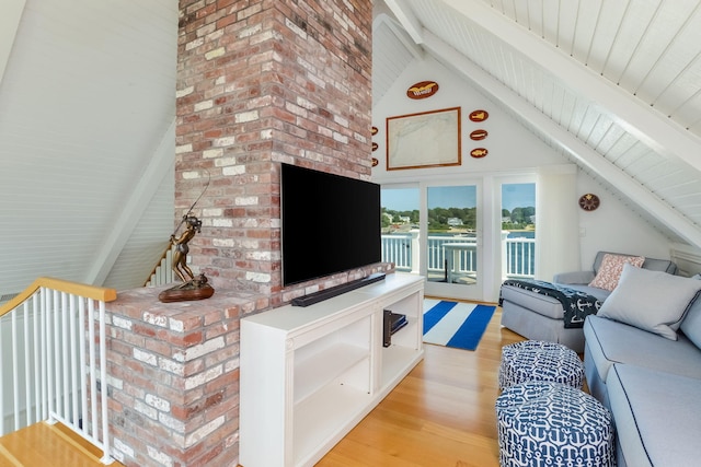 living room with light hardwood / wood-style floors, high vaulted ceiling, and beam ceiling