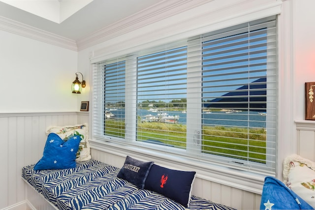 interior space with ornamental molding and a water view