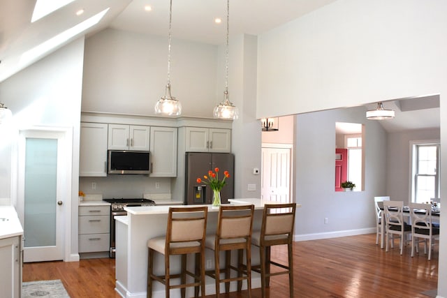 55 Blue Castle Dr, Mashpee, MA 02649 - kitchen with stainless steel appliances, high vaulted ceiling, light wood-style floors, light countertops, and a skylight