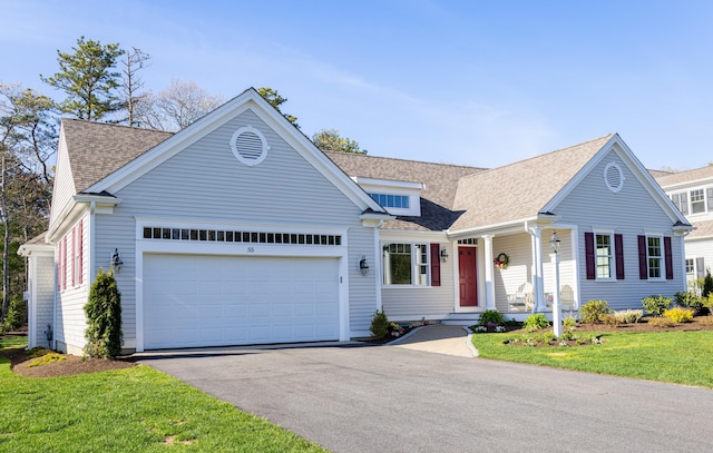 55 Blue Castle Dr, Mashpee, MA 02649 - view of front facade with driveway, a garage, roof with shingles, and a porch
