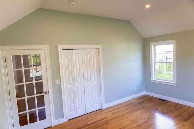 55 Blue Castle Dr, Mashpee, MA 02649 - unfurnished bedroom featuring vaulted ceiling, wood finished floors, a closet, and baseboards
