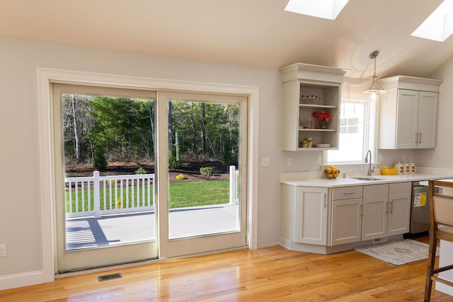 55 Blue Castle Dr, Mashpee, MA 02649 - kitchen with a sink, a skylight, open shelves, and plenty of natural light
