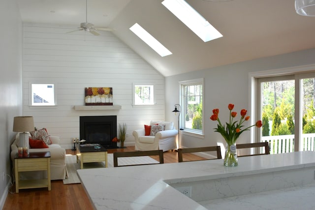55 Blue Castle Dr, Mashpee, MA 02649 - living room with a fireplace with flush hearth, wood finished floors, high vaulted ceiling, a ceiling fan, and baseboards