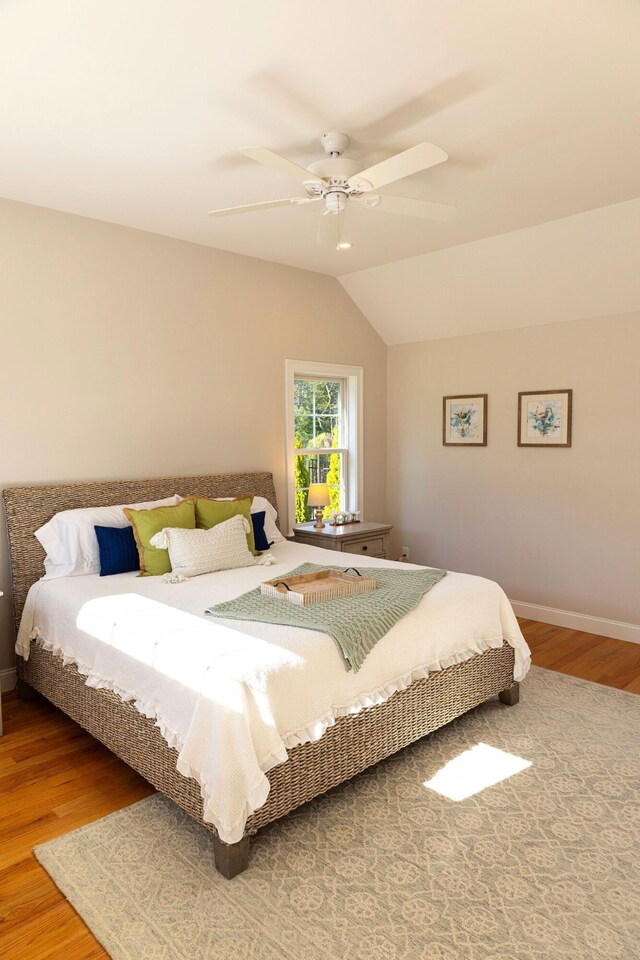 55 Blue Castle Dr, Mashpee, MA 02649 - bedroom with wood finished floors, baseboards, vaulted ceiling, and ceiling fan