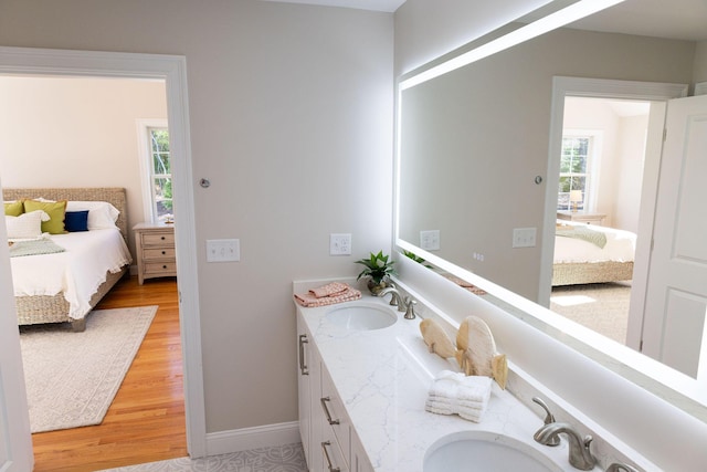 55 Blue Castle Dr, Mashpee, MA 02649 - ensuite bathroom with wood finished floors, double vanity, and baseboards