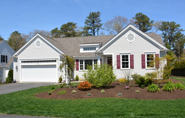55 Blue Castle Dr, Mashpee, MA 02649 - view of front facade with driveway, a shingled roof, a front yard, and a garage