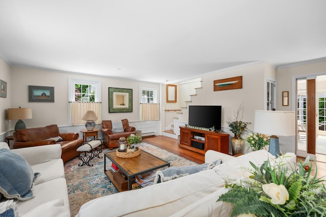 5 Putnam Ave, Cotuit, MA 02635 - living area with crown molding, stairway, wood finished floors, and a baseboard radiator