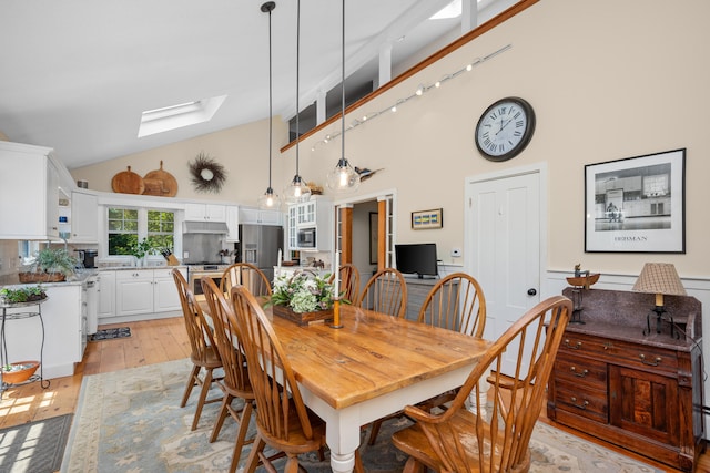 5 Putnam Ave, Cotuit, MA 02635 - dining area featuring a skylight, high vaulted ceiling, and light wood finished floors