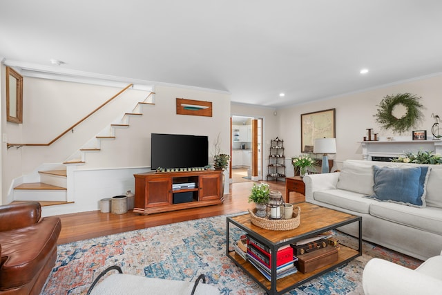 5 Putnam Ave, Cotuit, MA 02635 - living area with wood finished floors, stairs, crown molding, and recessed lighting