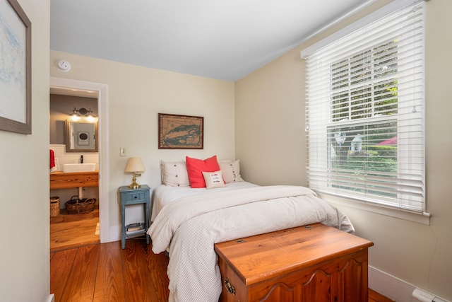 5 Putnam Ave, Cotuit, MA 02635 - bedroom featuring dark wood-style floors, a baseboard heating unit, and multiple windows