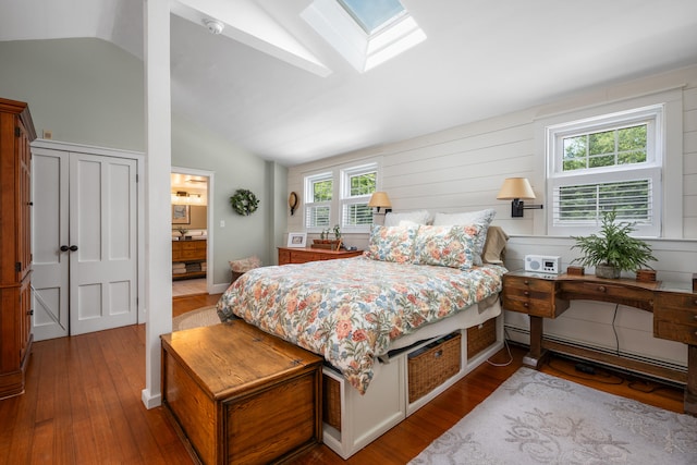 5 Putnam Ave, Cotuit, MA 02635 - bedroom with a baseboard heating unit, wood finished floors, vaulted ceiling, a skylight, and ensuite bath