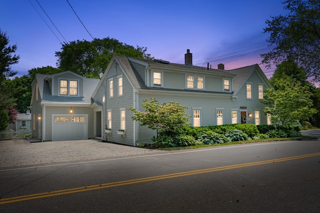 5 Putnam Ave, Cotuit, MA 02635 - view of front of house with a chimney, roof with shingles, and driveway