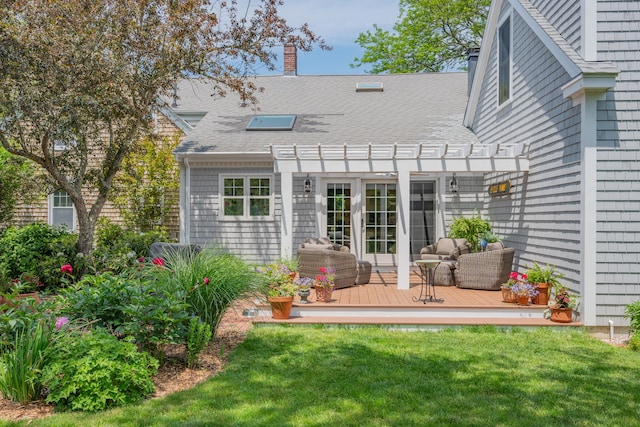 5 Putnam Ave, Cotuit, MA 02635 - back of property with a pergola, a wooden deck, a chimney, roof with shingles, and a yard