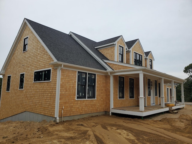 view of side of property with a porch