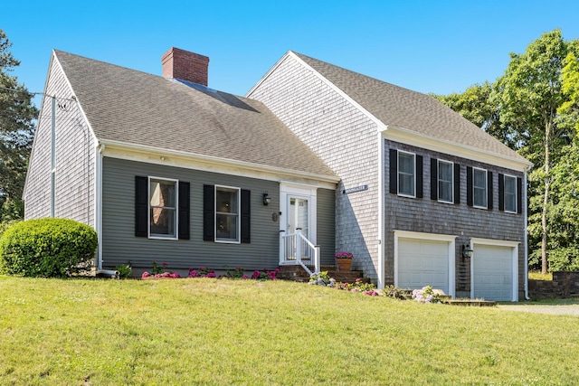 46 Juniper Ln W, South Chatham, MA 02659 - view of front of home with a garage, a chimney, roof with shingles, and a front yard