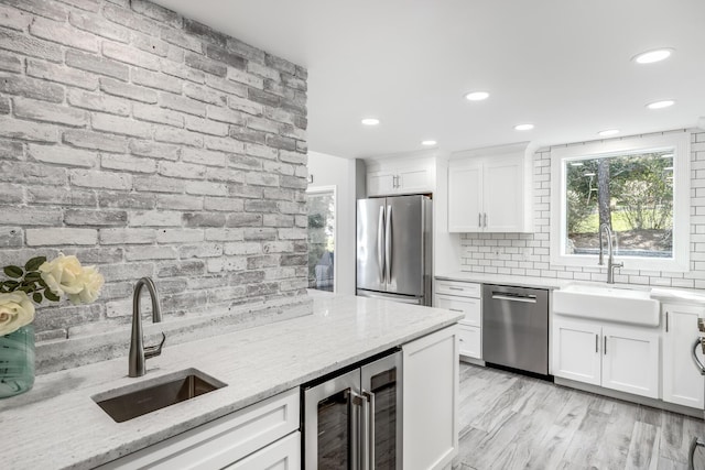 46 Juniper Ln W, South Chatham, MA 02659 - kitchen with beverage cooler, a sink, tasteful backsplash, and stainless steel appliances