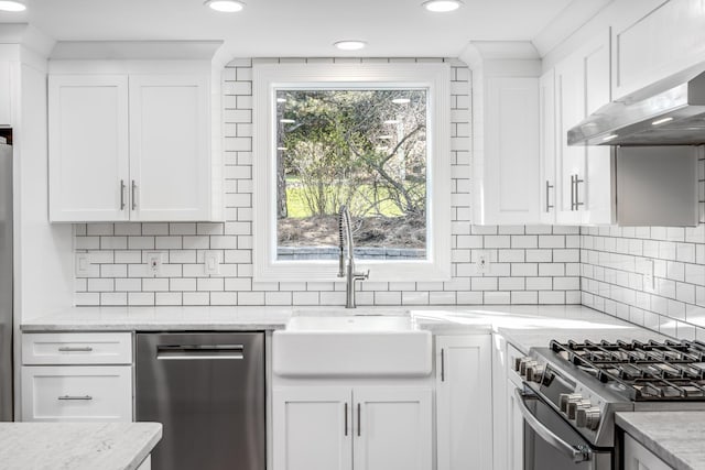 46 Juniper Ln W, South Chatham, MA 02659 - kitchen featuring white cabinetry, under cabinet range hood, tasteful backsplash, a sink, and appliances with stainless steel finishes
