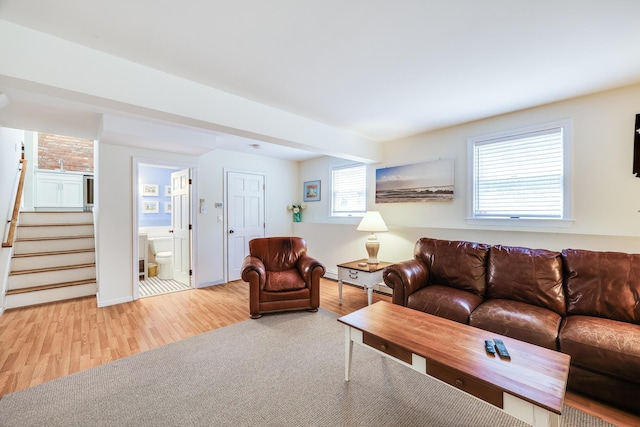 46 Juniper Ln W, South Chatham, MA 02659 - living room featuring stairway, baseboards, and light wood finished floors