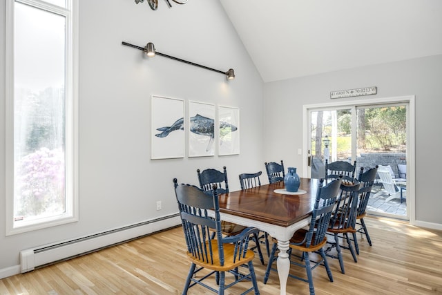 46 Juniper Ln W, South Chatham, MA 02659 - dining room featuring light wood-style floors, high vaulted ceiling, baseboards, and a baseboard heating unit