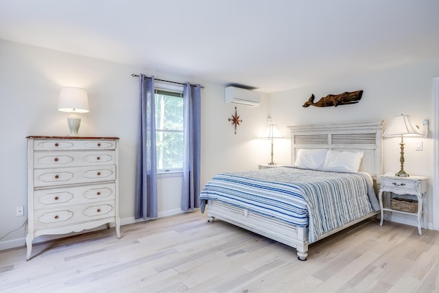 46 Juniper Ln W, South Chatham, MA 02659 - bedroom with baseboards, a wall mounted air conditioner, and wood finished floors