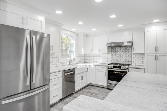 46 Juniper Ln W, South Chatham, MA 02659 - kitchen featuring appliances with stainless steel finishes, a sink, white cabinets, light wood-style floors, and under cabinet range hood