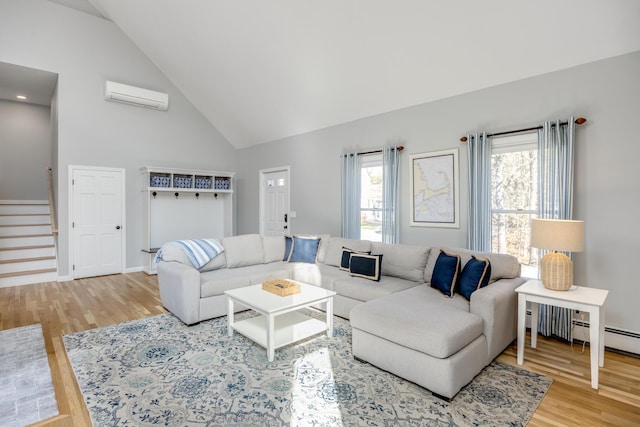 46 Juniper Ln W, South Chatham, MA 02659 - living room featuring stairs, a wall unit AC, a healthy amount of sunlight, and wood finished floors