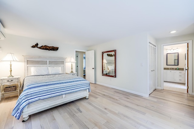 46 Juniper Ln W, South Chatham, MA 02659 - bedroom with light wood-style floors, baseboards, and ensuite bath