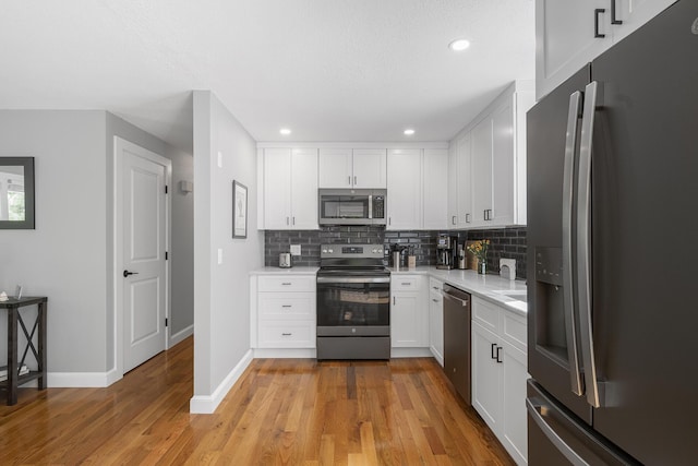 29 Braeburn Ct, Hatchville, MA 02536 - kitchen featuring stainless steel appliances, tasteful backsplash, light countertops, baseboards, and light wood-style floors