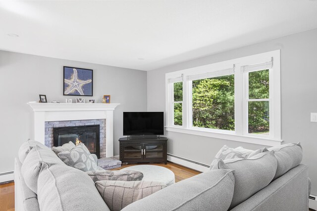 29 Braeburn Ct, Hatchville, MA 02536 - living area with baseboard heating, wood finished floors, and a fireplace