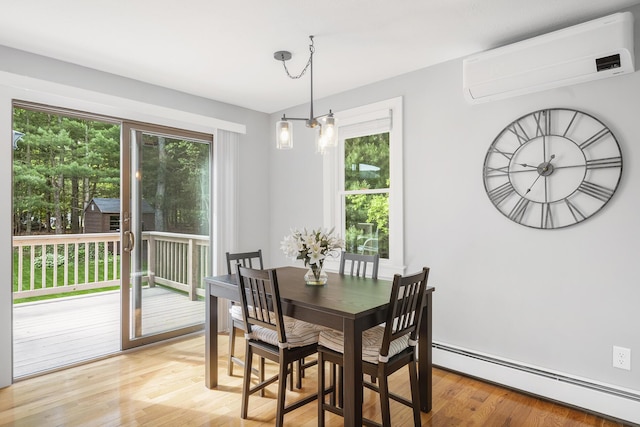 29 Braeburn Ct, Hatchville, MA 02536 - dining area featuring a wall mounted AC, a baseboard radiator, plenty of natural light, and light wood-type flooring
