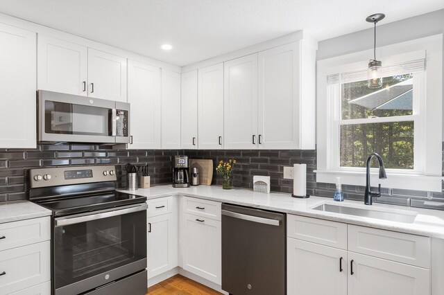 29 Braeburn Ct, Hatchville, MA 02536 - kitchen with stainless steel appliances, a sink, white cabinetry, tasteful backsplash, and recessed lighting
