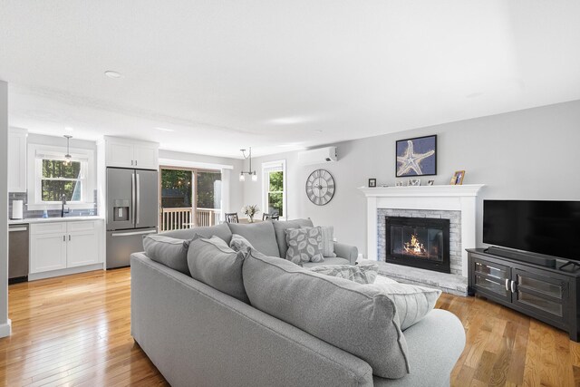 29 Braeburn Ct, Hatchville, MA 02536 - living area with a wall mounted AC, healthy amount of natural light, and light wood-style flooring