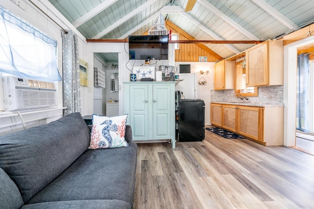 living room with lofted ceiling with beams and light wood-type flooring