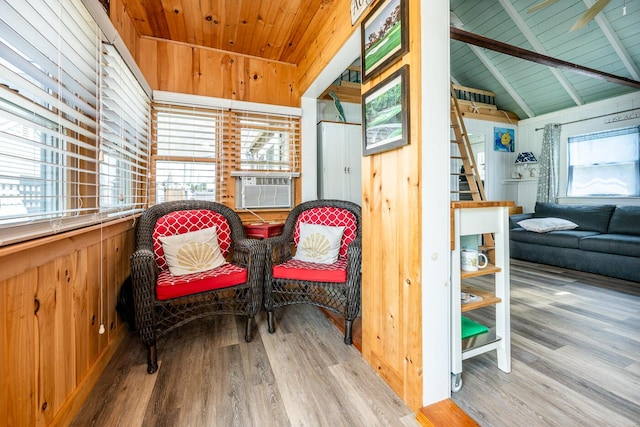 sitting room with hardwood / wood-style flooring, cooling unit, wooden ceiling, and lofted ceiling