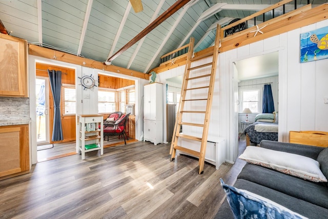 interior space featuring wooden walls, hardwood / wood-style floors, lofted ceiling with beams, and wood ceiling