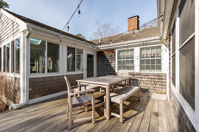 wooden deck featuring outdoor dining area