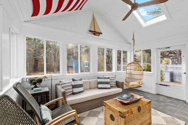 sunroom featuring lofted ceiling with skylight and ceiling fan