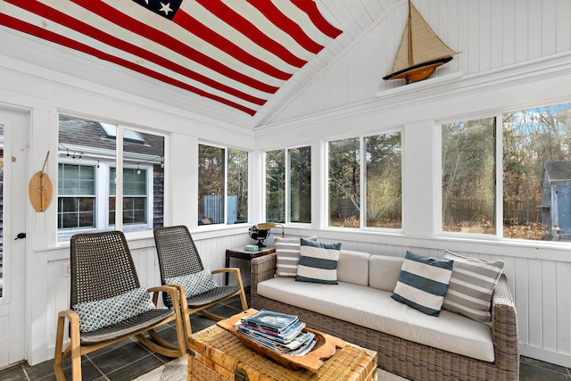 sunroom with plenty of natural light and vaulted ceiling