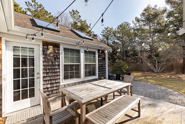 deck featuring outdoor dining area and fence