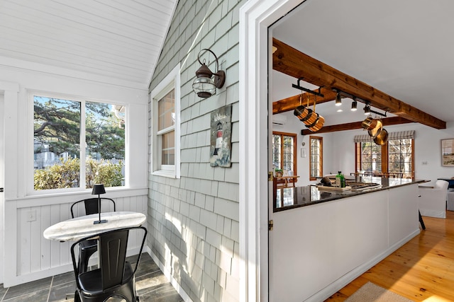 interior space with vaulted ceiling with beams and wood finished floors