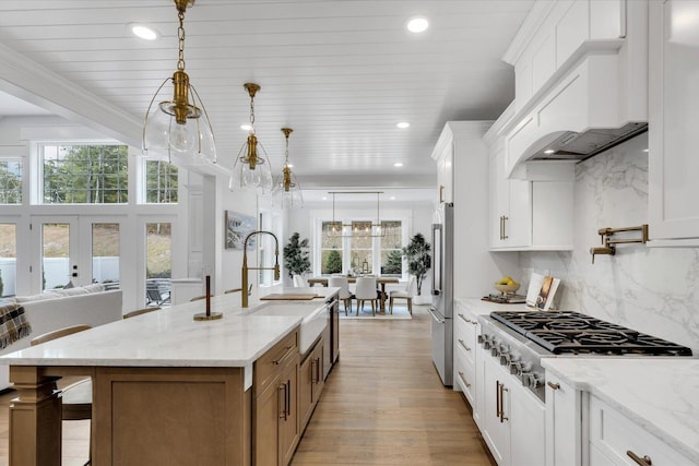 22 Country Club Ln, Mashpee, MA 02649 - kitchen featuring a wealth of natural light, a center island with sink, stainless steel appliances, and a sink